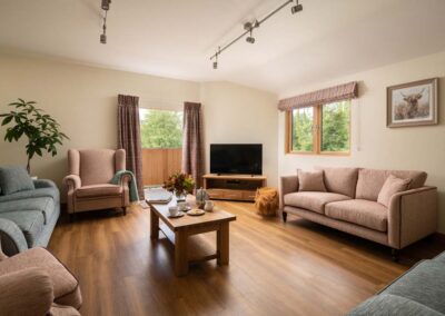 TV lounge in Scots Pine seats 10 people and has patio doors to a shared balcony