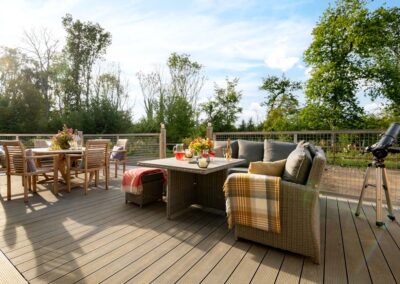 Relax on the decking at Portuguese Laurel woodland holiday house in Hampshire